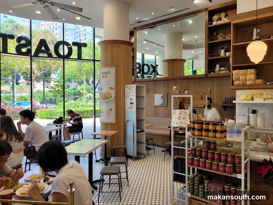 Interior of a cafe with customers dining and products on display