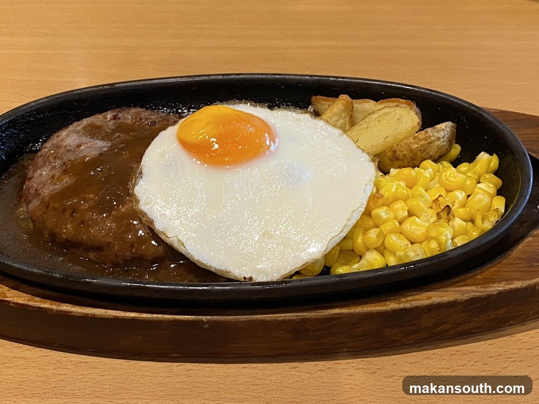 Sizzling Steak Plate with Egg and Corn