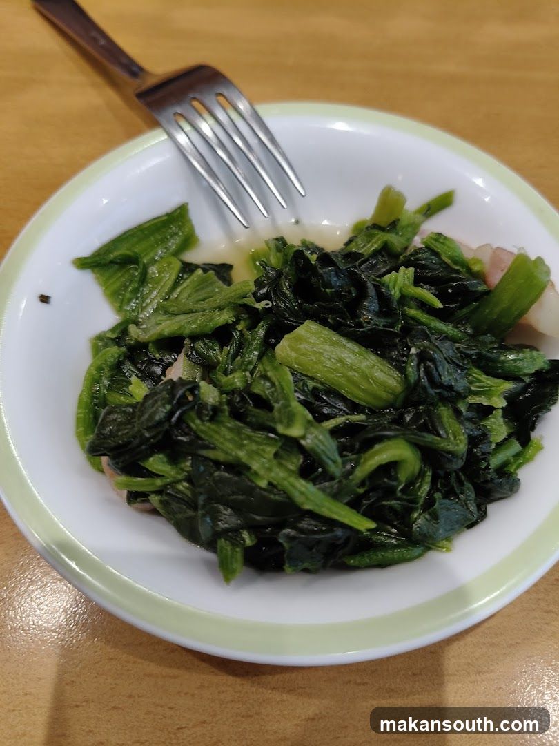 Stir-fried greens with fork
