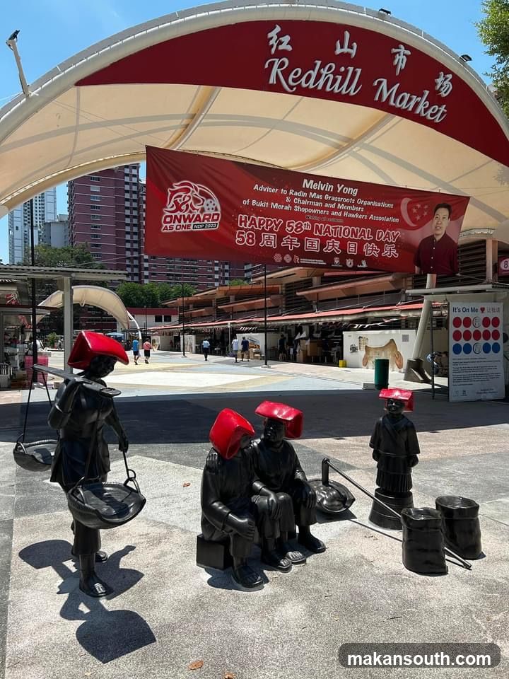 Redhill Market Entrance with Statues and Banner