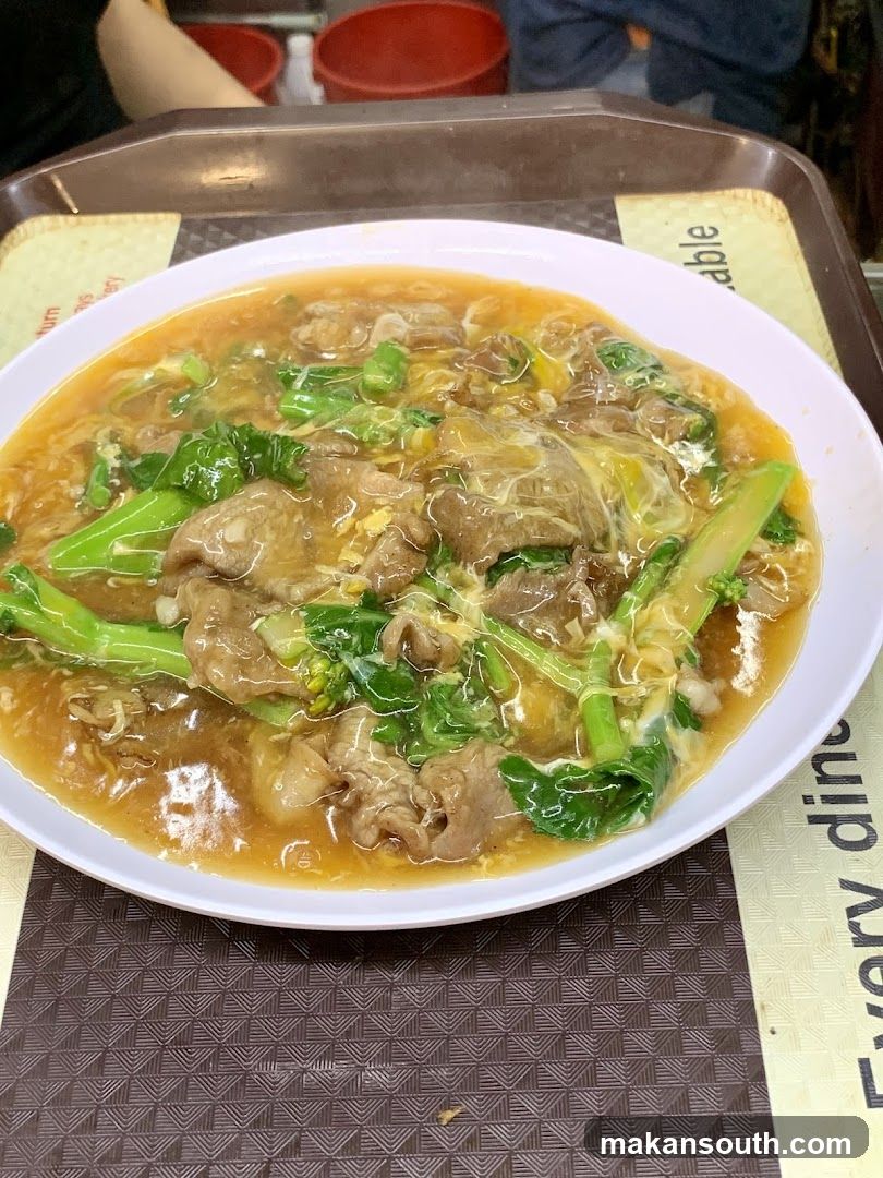 Bowl of Noodle Soup with Meat and Greens