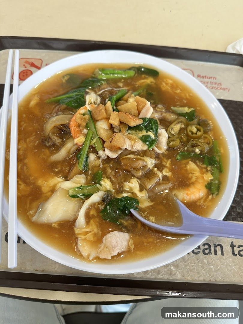 Bowl of Noodle Soup with Vegetables and Seafood