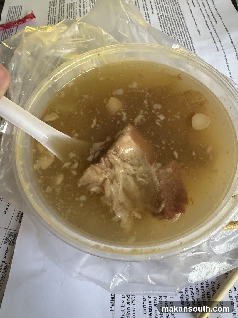 Bowl of Soup with Meat and Spoons