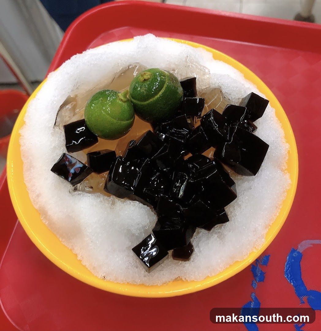 Bowl of shaved ice dessert with lime and jelly cubes