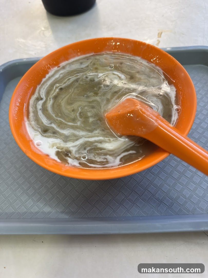 Bowl of Soup with Orange Spoon