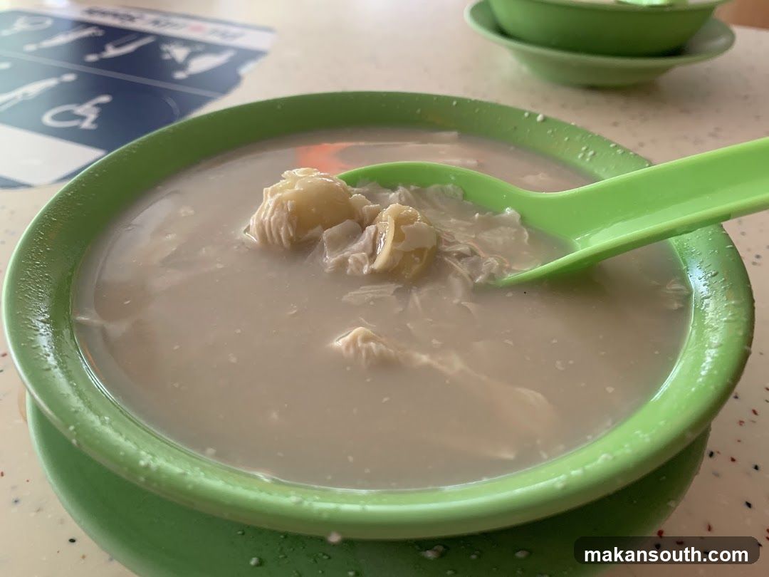 Green bowl of soup with spoon