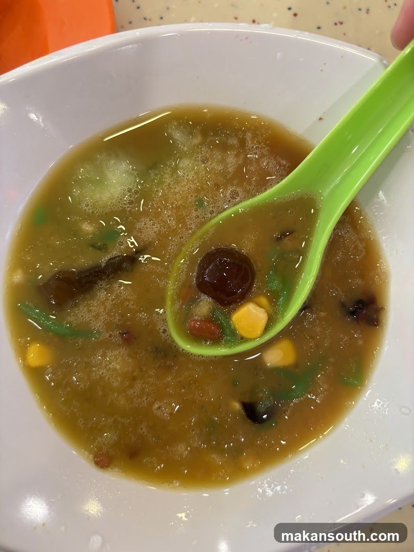 Soup in bowl with green spoon