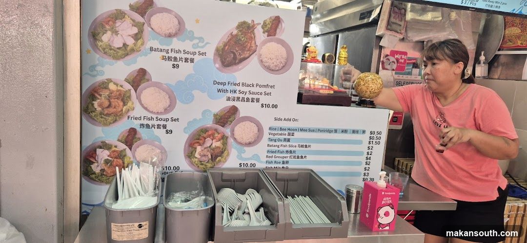 Food stall interior with staff and menu board