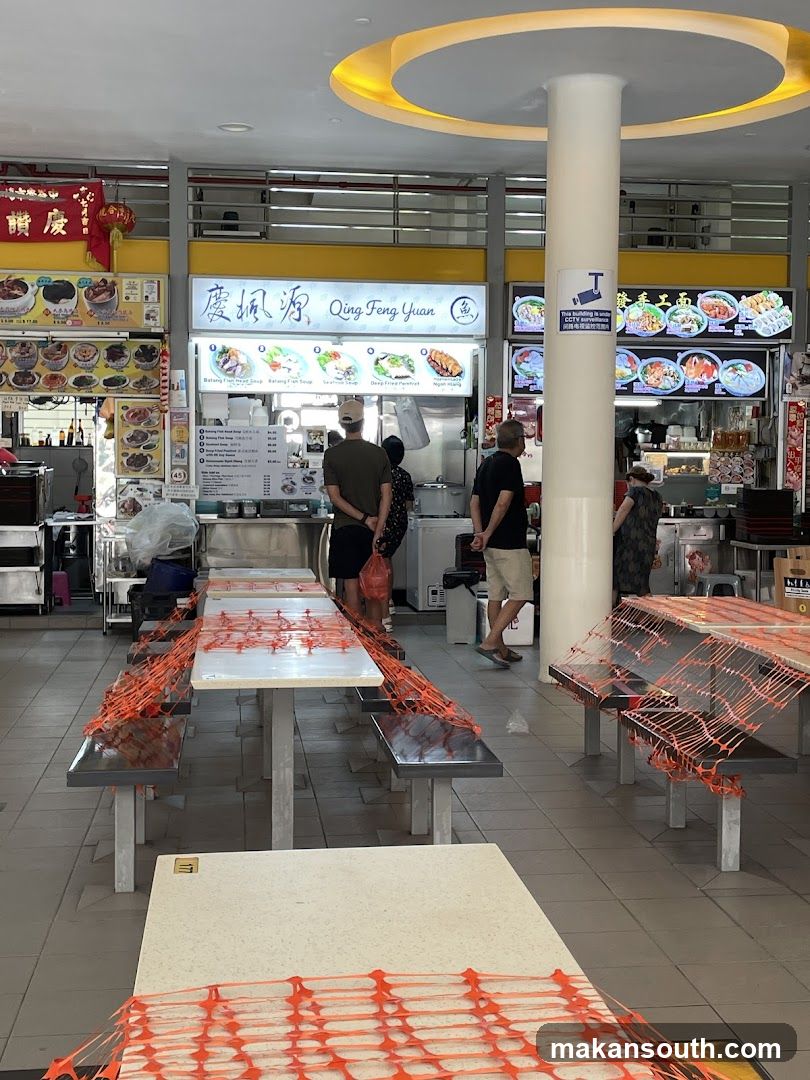 Food court interior with dining tables and food stalls