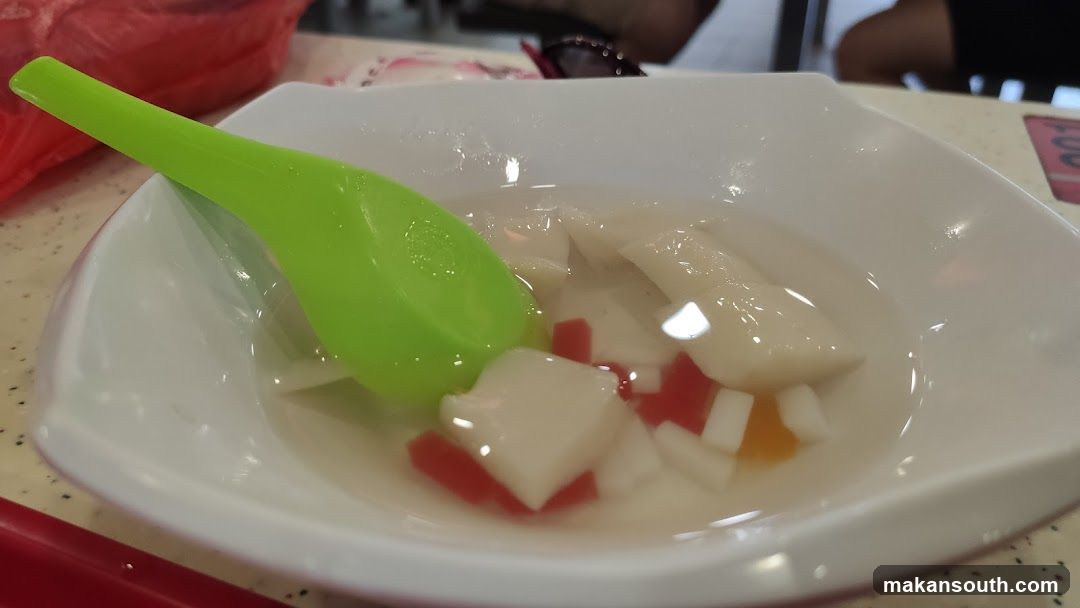 Food in a bowl with green spoon