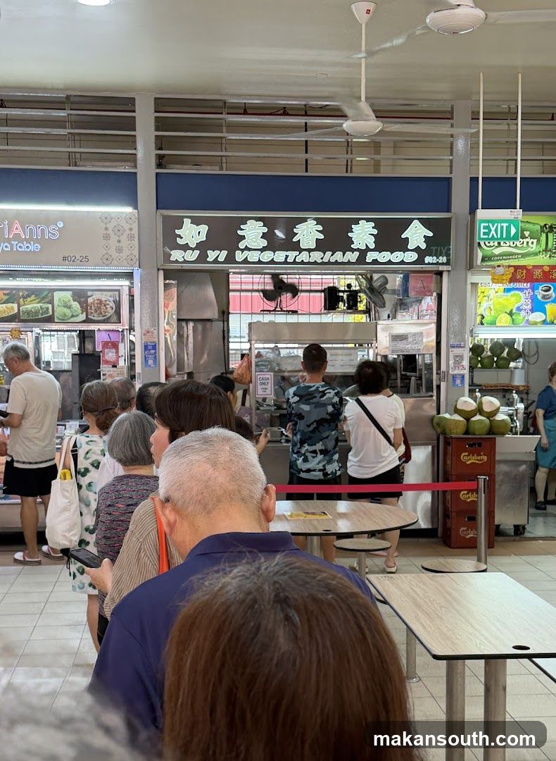 Interior of a hawker center with customers and food stalls