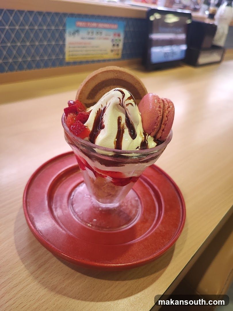 Dessert in glass cup with macaron and waffle