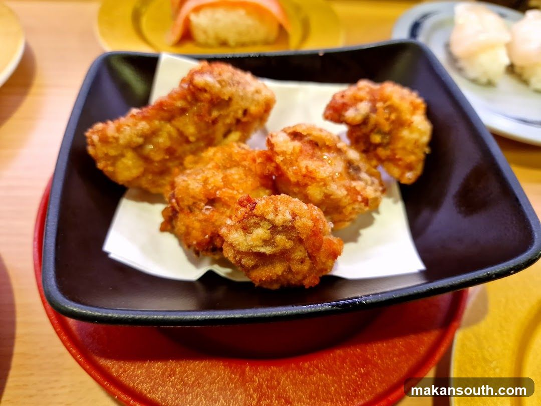 Fried Chicken Pieces on a Black Plate