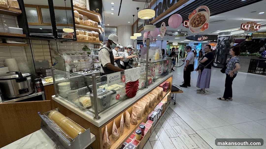 Food Stall Interior with Staff and Customers