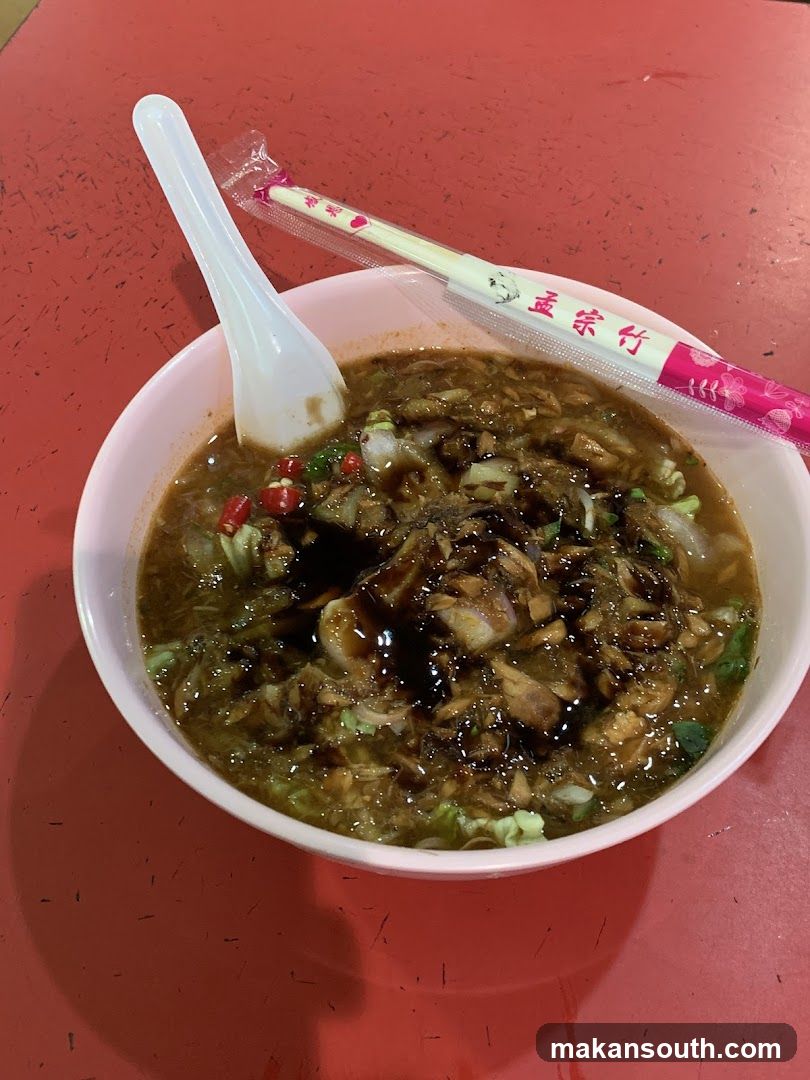 Bowl of Noodle Soup with Chopsticks and Spoon