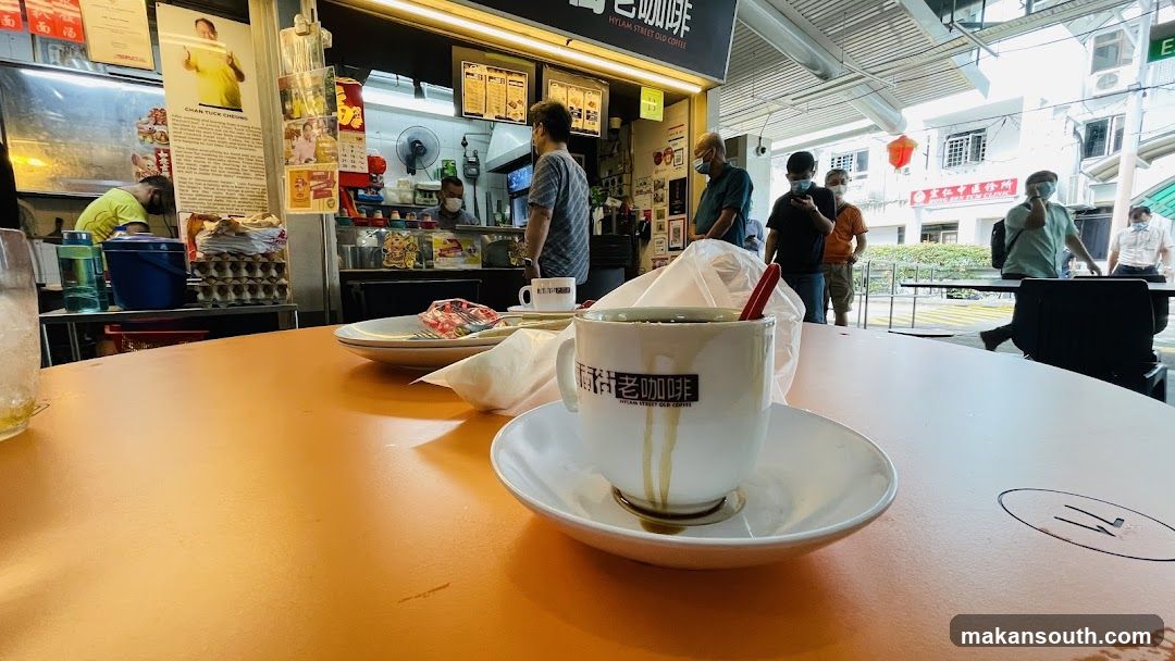 Cafe Interior with Coffee Cup and Staff
