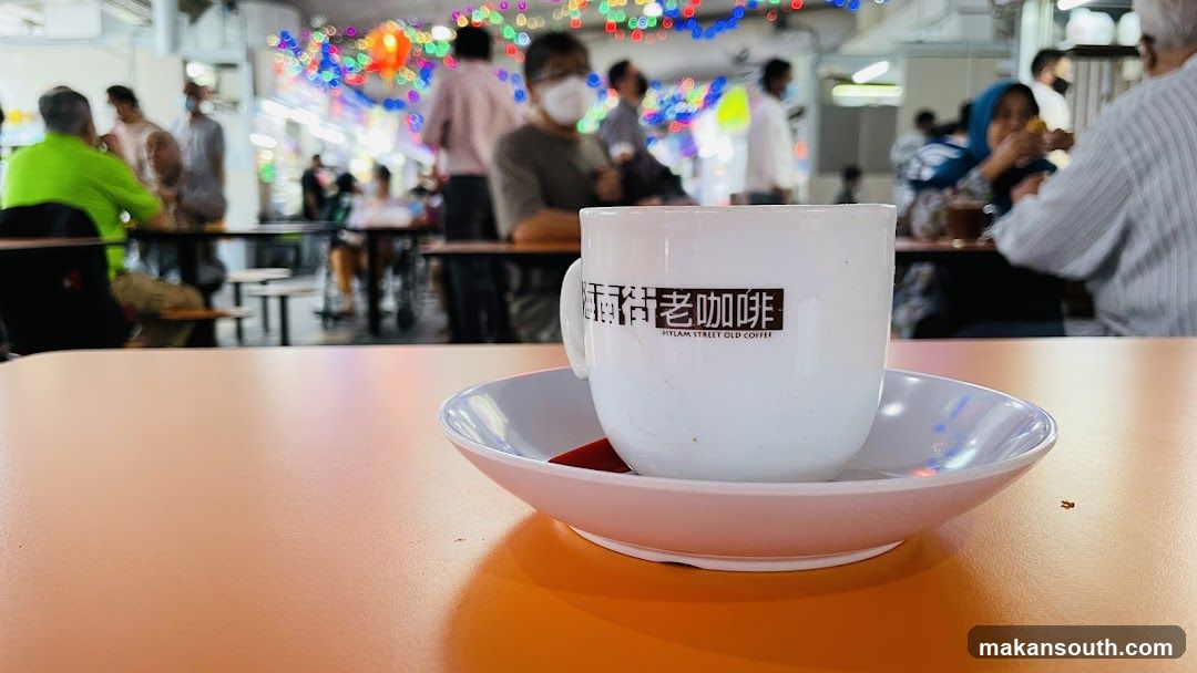 Coffee Cup in Busy Cafe Interior