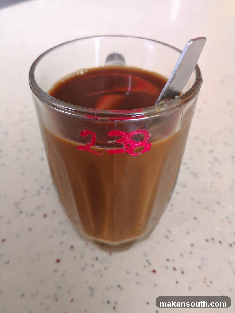 Cup of beverage with spoon
