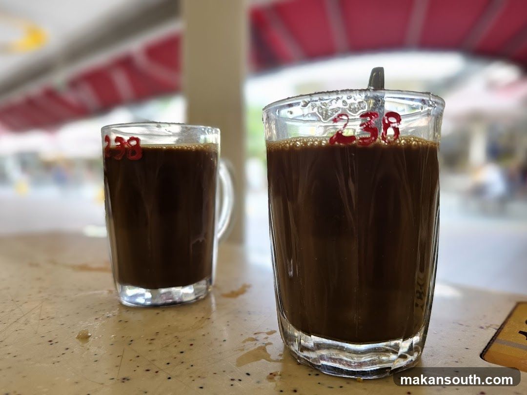 Two glasses of dark beverage on a table