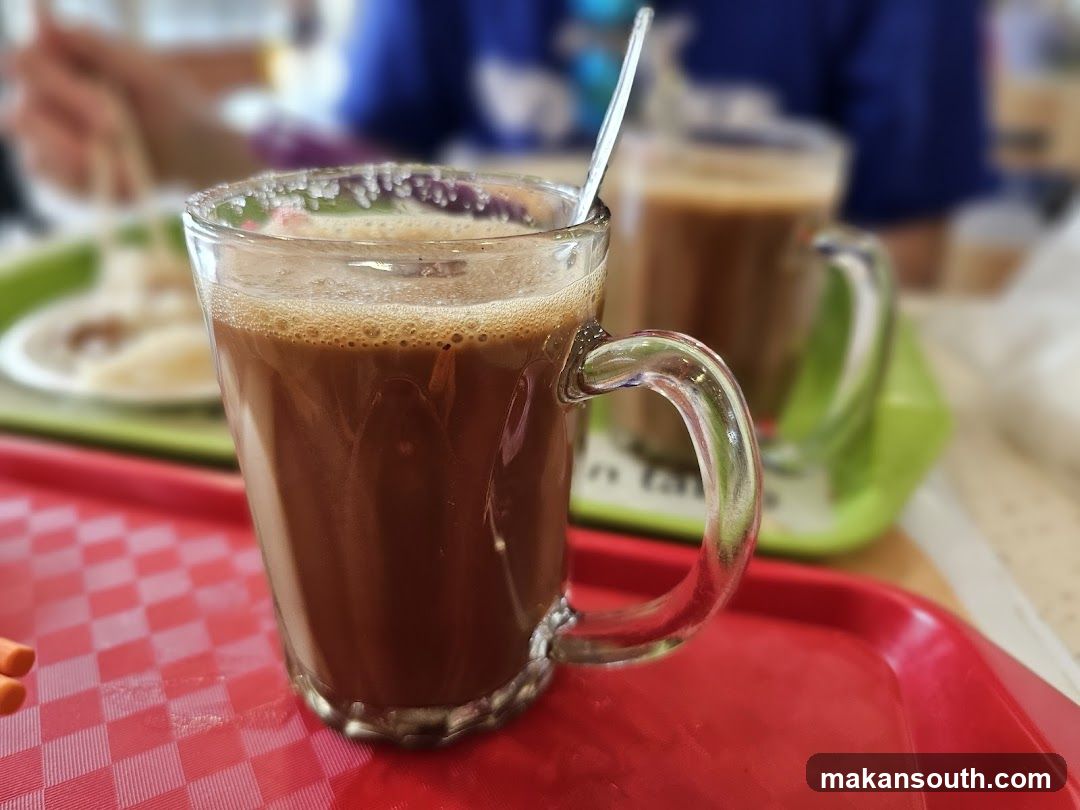 Coffee in a glass mug on a red tray