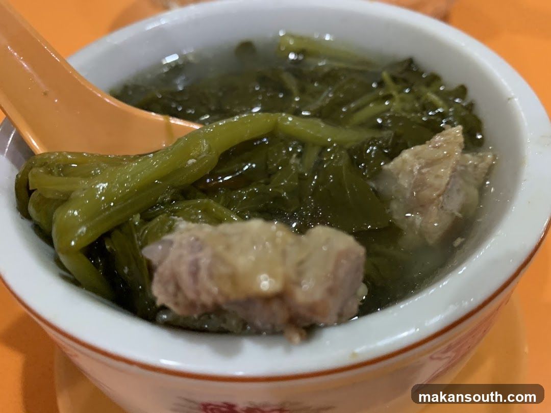 Bowl of Green Vegetable Soup with Meat