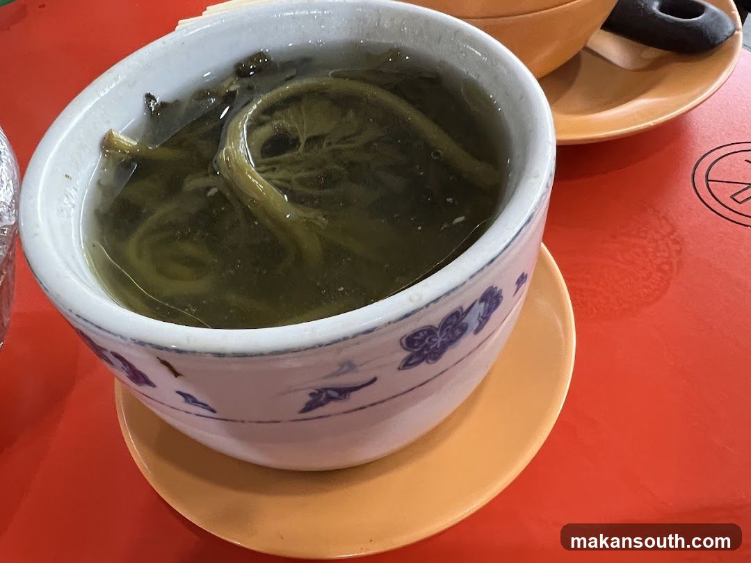 Bowl of Green Tea with Leaves