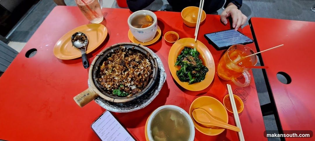 Dining Table with Claypot Rice and Side Dishes