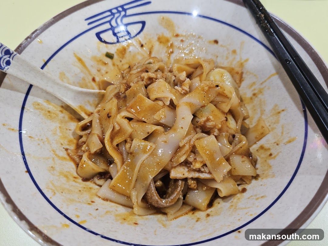 Bowl of Noodles with Sauce and Chopsticks