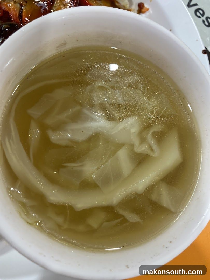 Bowl of clear soup with noodles and vegetables