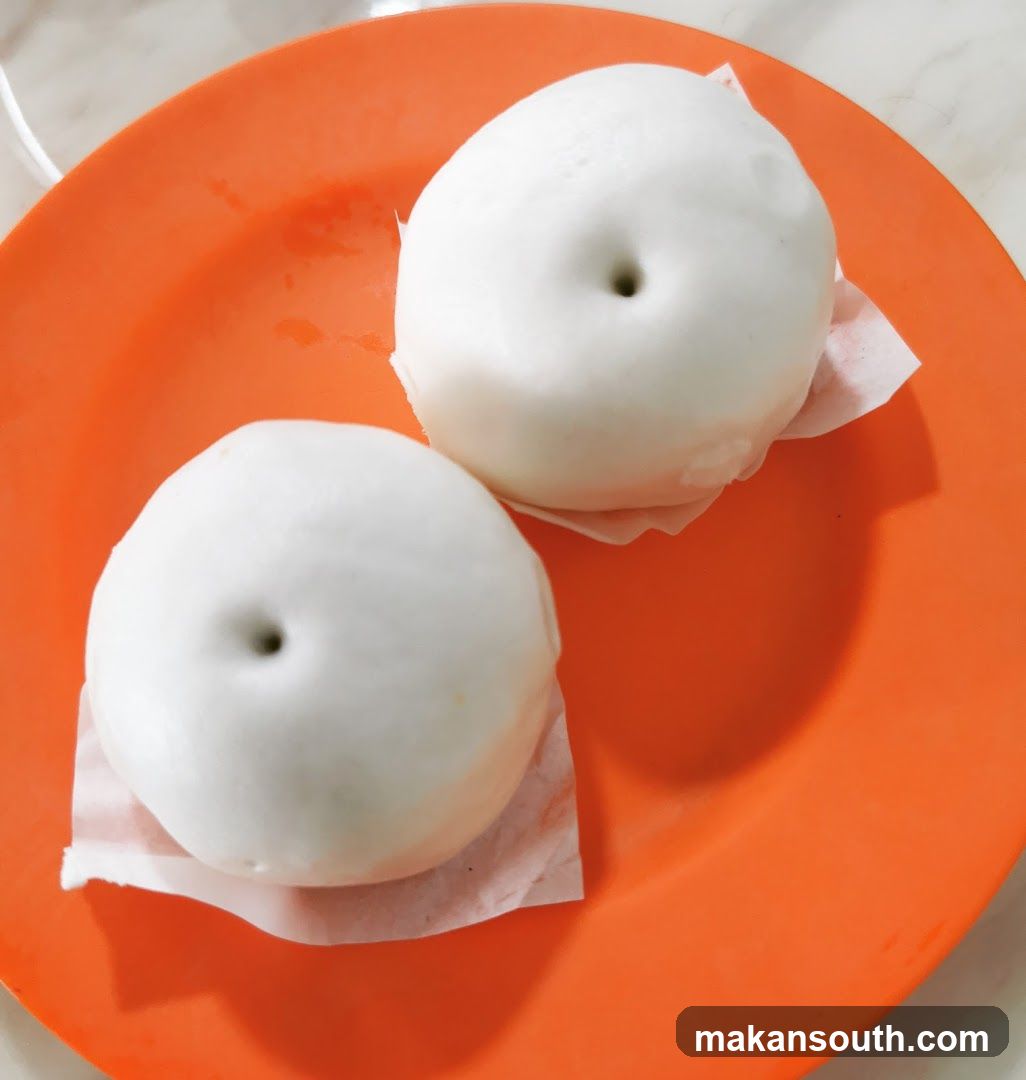White Steamed Buns on Orange Plate