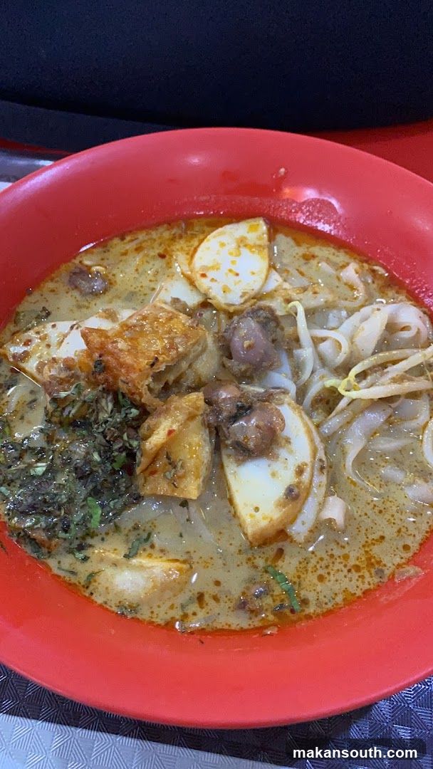 Red Bowl of Noodle Soup with Tofu and Egg