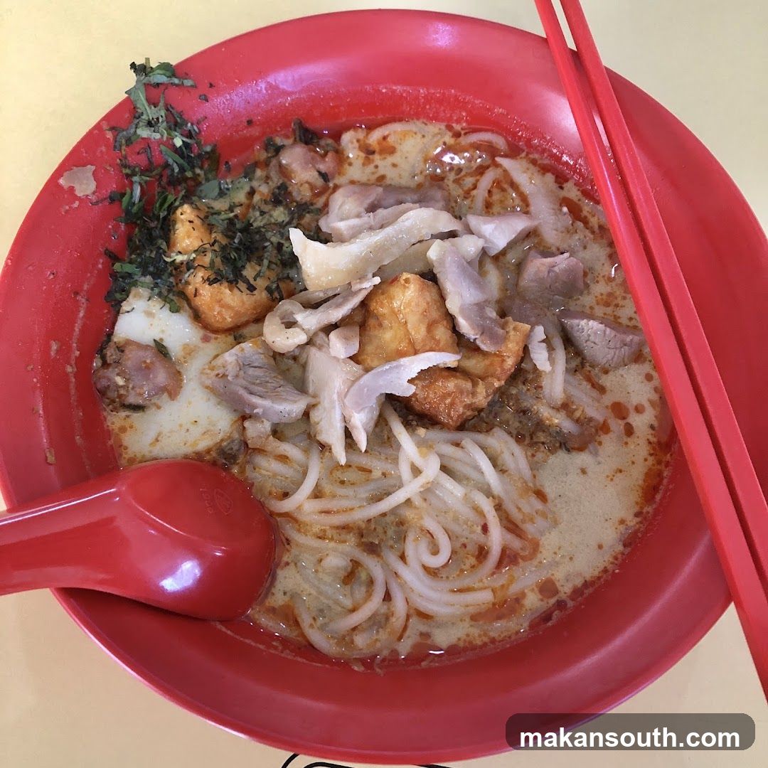 Red Bowl of Noodle Soup with Tofu and Meat