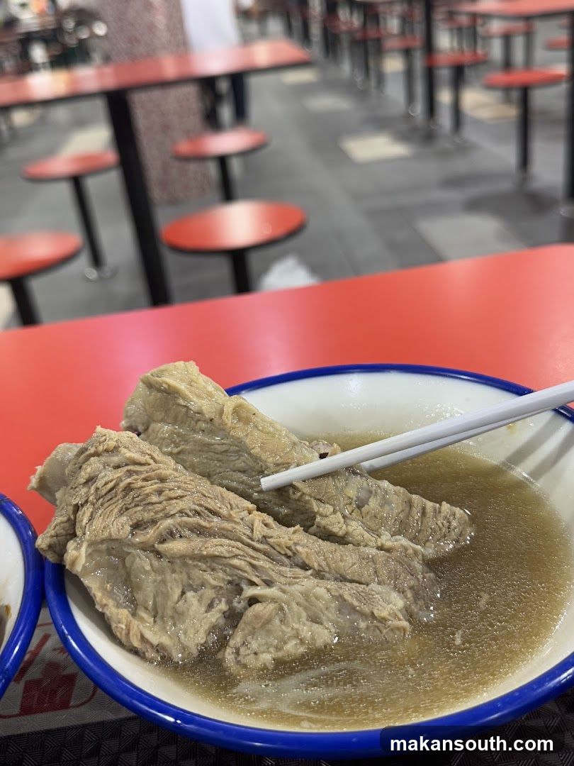 Bowl of beef soup in a canteen setting