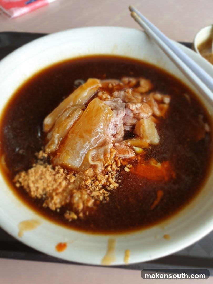Bowl of Dark Broth with Tofu and Meat