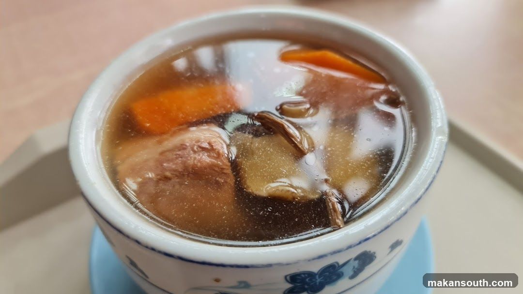 Bowl of Soup with Meat and Carrots
