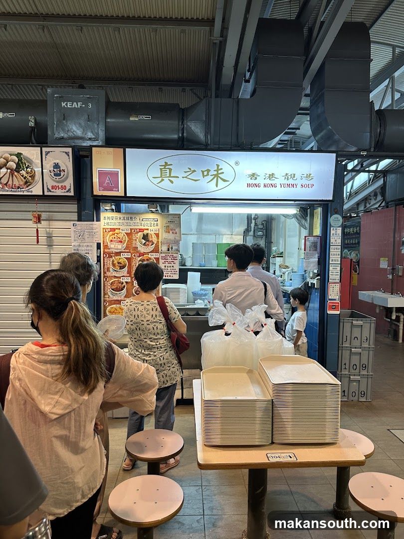Food stall interior with customers and staff