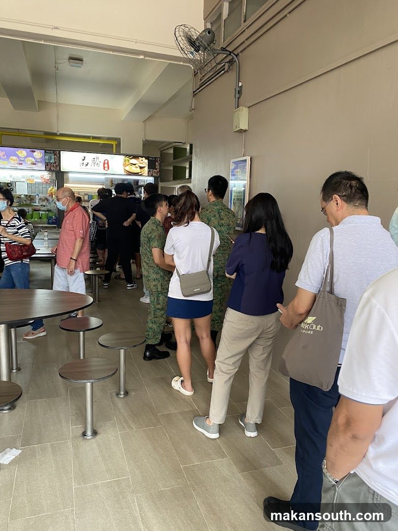 People queuing at a food stall