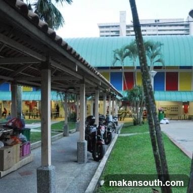 Covered walkway with parked motorcycles and shops