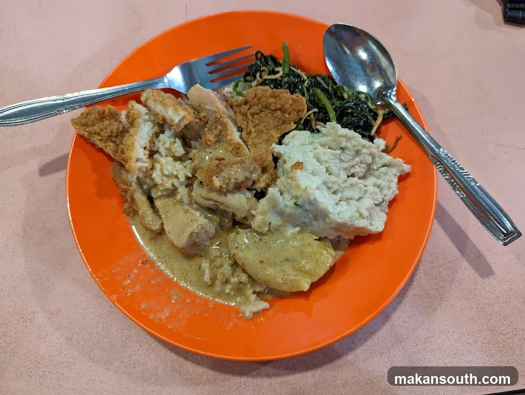 Plate of food with fried chicken and vegetables