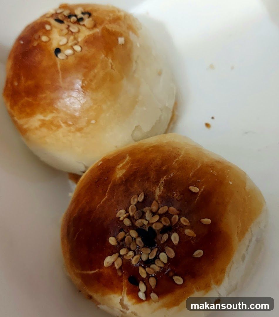 Two baked pastries with sesame seeds