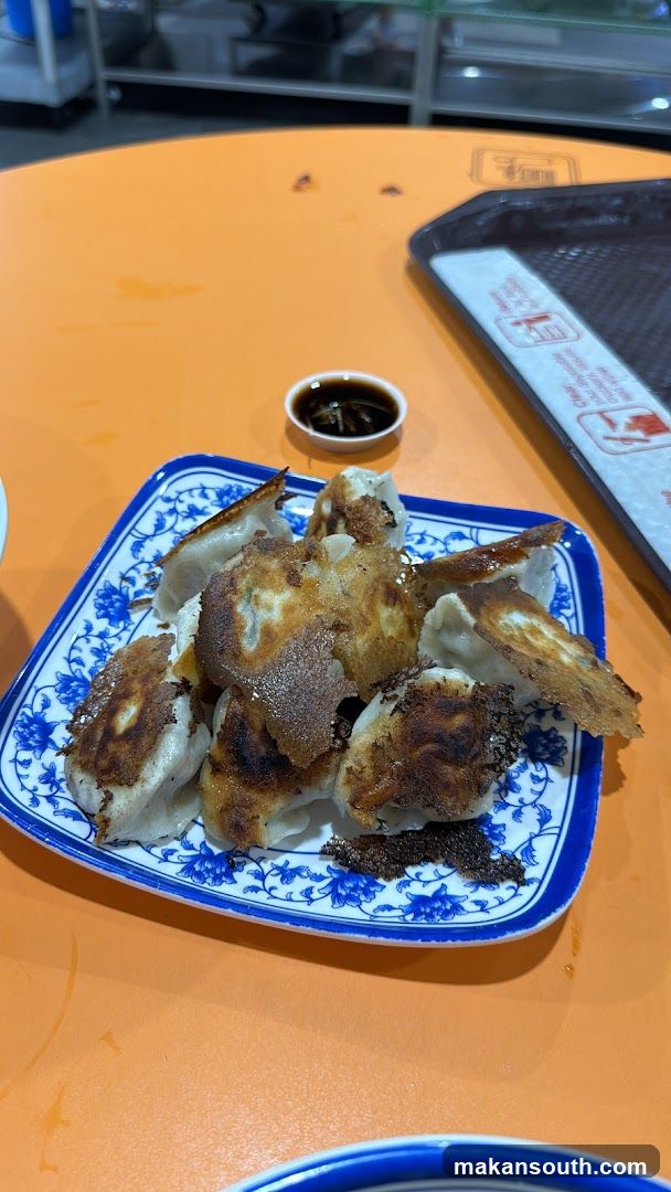 Pan-fried dumplings with dipping sauce