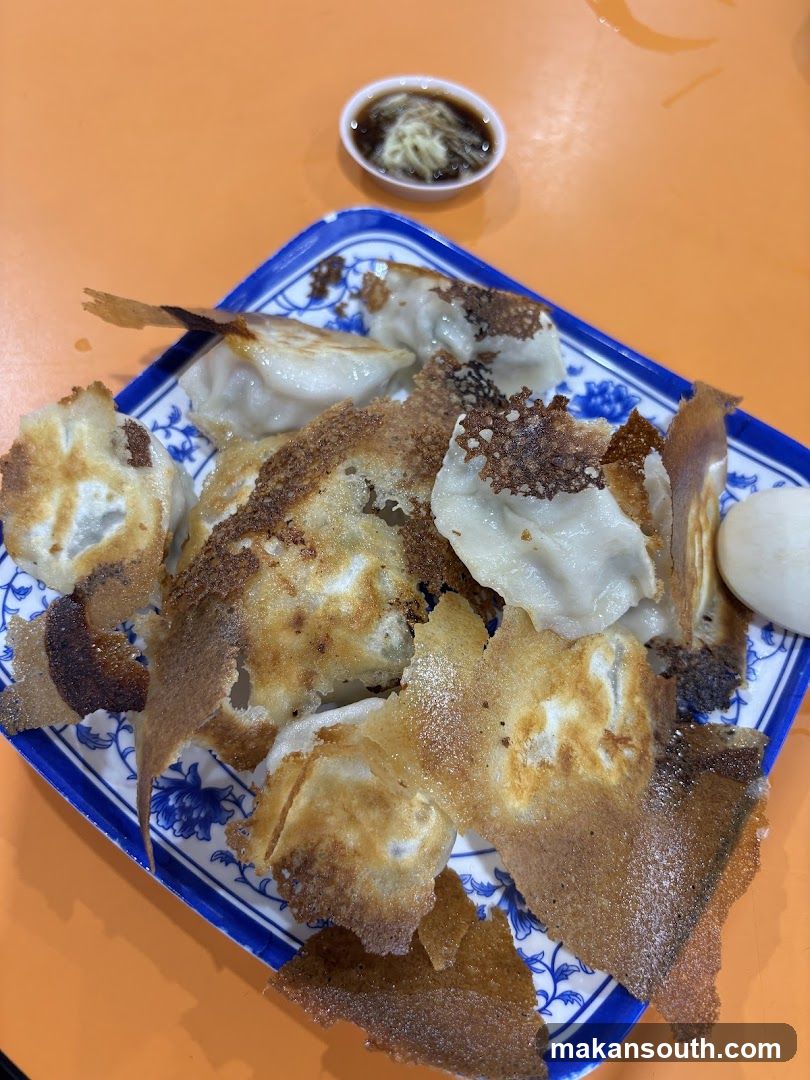 Pan-fried dumplings with dipping sauce