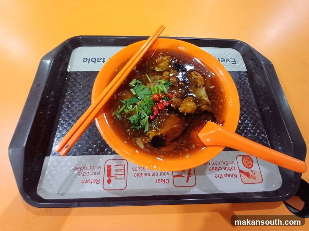 Bowl of Food with Chopsticks and Spoon