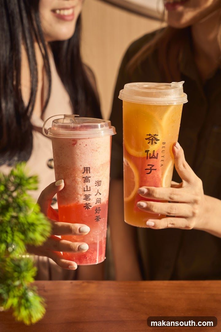 Two people holding bubble tea drinks