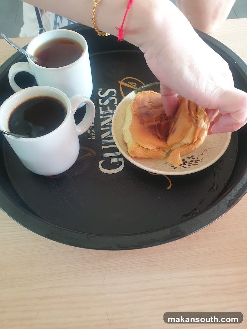 Tray with coffee, tea, and a bun