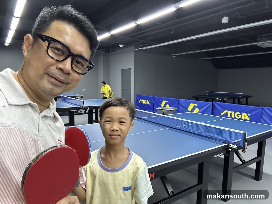 Father and son at a table tennis facility