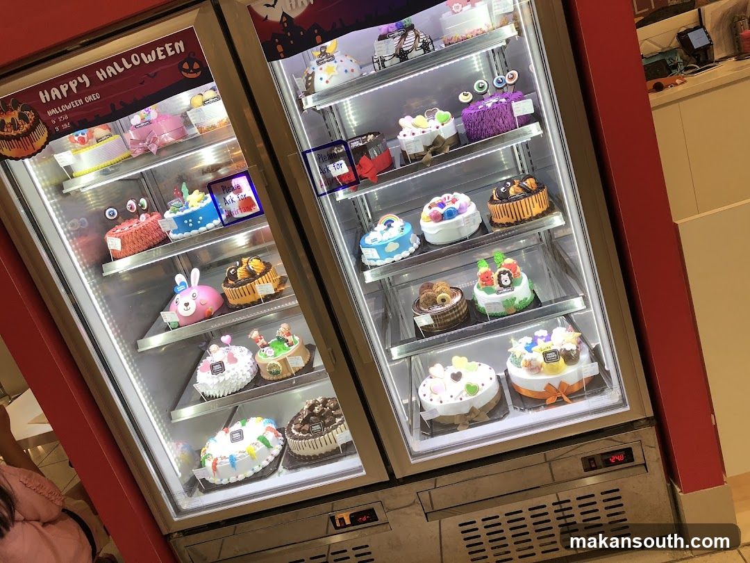 Halloween Themed Cakes in a Display Refrigerator