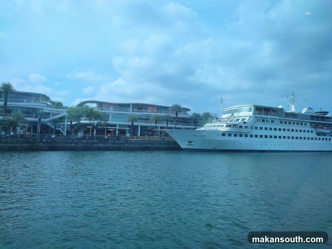 Cruise Ship Docked Near Waterfront Buildings