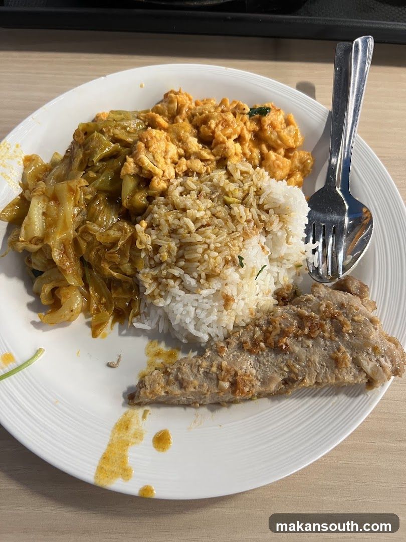Plate of food with rice, meat, and vegetables
