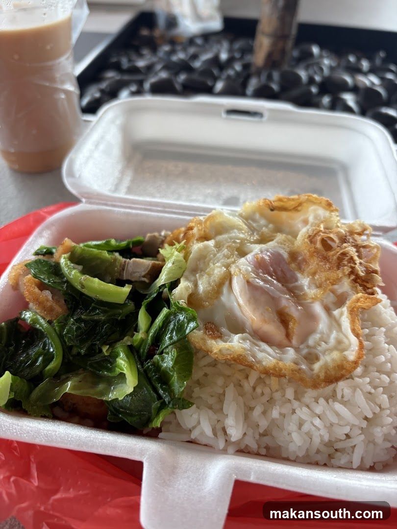 Rice dish with fried egg and vegetables